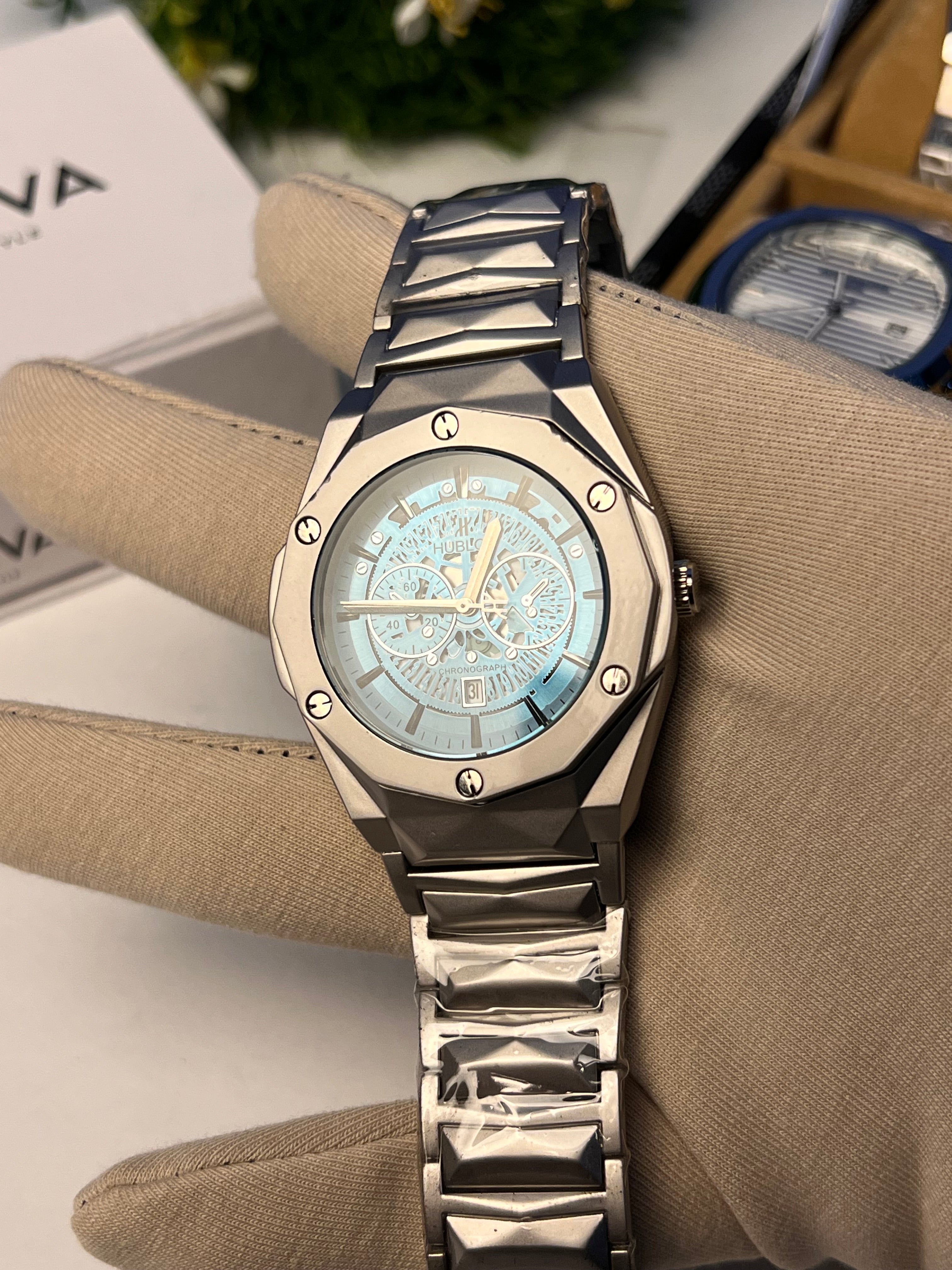 Hublot Diamond cut with a metallic case and a blue dial.