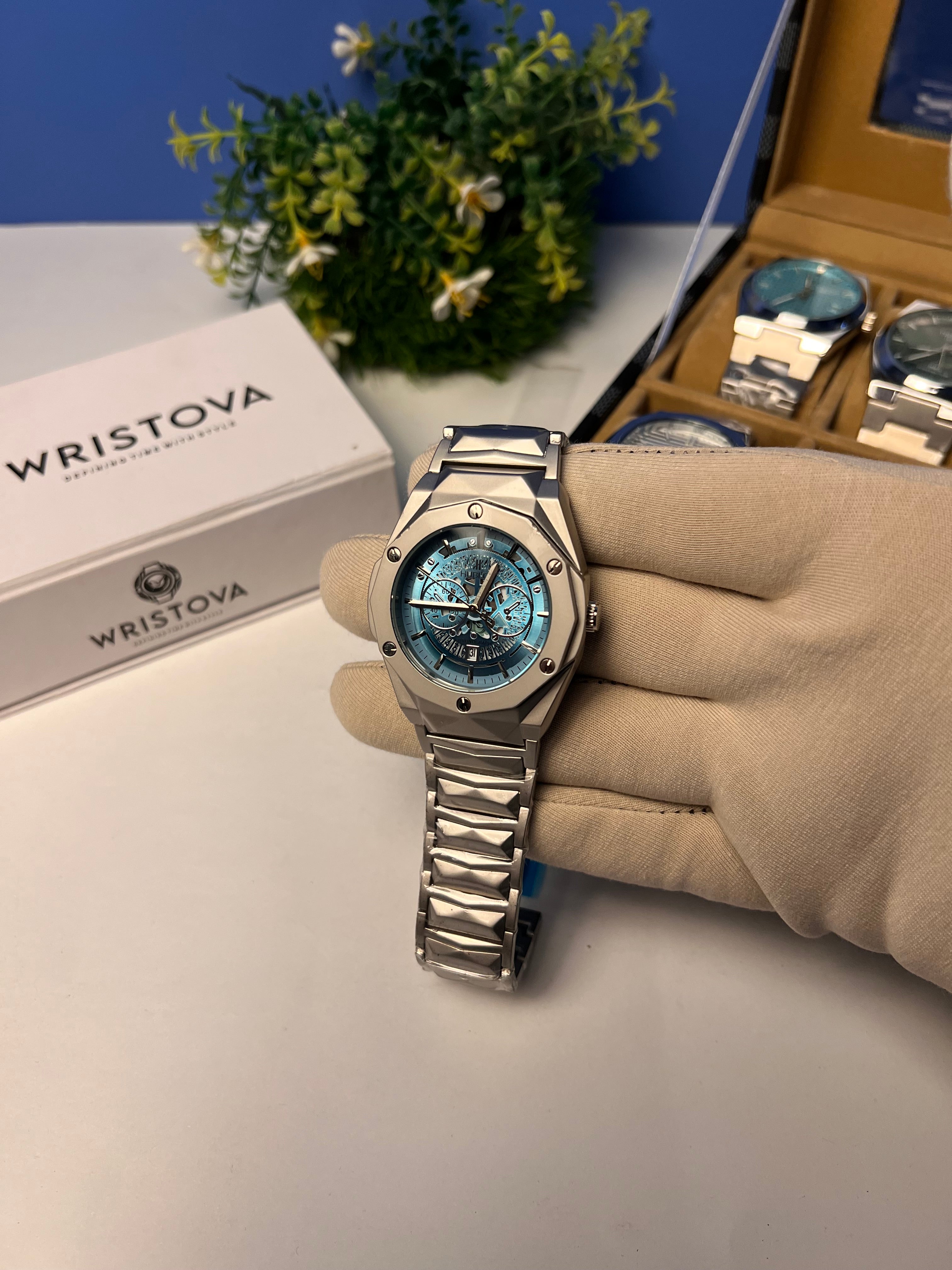 Hublot Diamond cut with a metallic case and a blue dial.